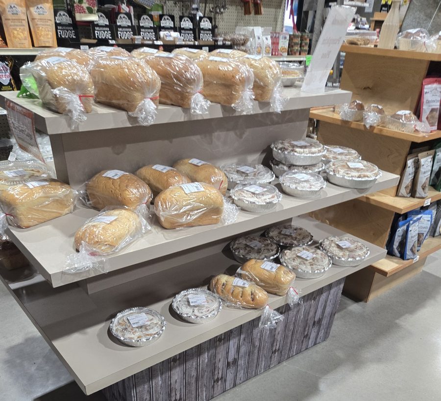 Fresh bread loaves and cinnamon rolls on the bakery display
