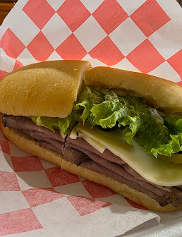 Roast beef, cheese and lettuce sandwich on a roll